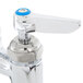 A T&amp;S chrome deck-mount sink faucet with blue handles.