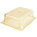 A Vollrath 1/2 size amber plastic food pan with a lid on top.