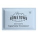 A blue packet of Hometown Provisions zero calorie aspartame sweetener.