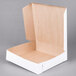 A plain white, open, square bakery box with a natural brown interior.