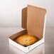 A white bakery box containing a whole pie with a golden crust.