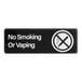 A rectangular black and white sign that reads 'No Smoking Or Vaping' with a crossed-out cigarette symbol.
