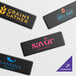 A set of customizable rectangular anti-fatigue mats with beveled edges, each featuring different business logos and designs.