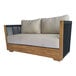 A modern outdoor love seat featuring a teak wood frame, black rope sides, and light-colored Sunbrella cushions.