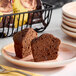 A gluten-free chocolate muffin cut in half and served on a plate.