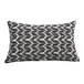 A rectangular lumbar pillow with a black leaf pattern on a white background.