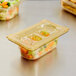 A close up of a plastic container with vegetables and salad in it.