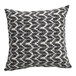A square pillow with a black leaf pattern on a white background.