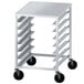 An Advance Tabco aluminum dough box rack with black wheels on the bottom.
