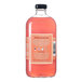 A 750 mL bottle of Stirrings Paloma Mix with a pink liquid and a black cap.