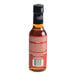 A 5 fl. oz. bottle of Merchants Exchange Orange Bitters with a black cap and a red label.