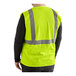 A lime green high visibility mesh safety vest with reflective stripes, shown from the back.