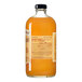 A 750 mL glass bottle of Stirrings Peach Bellini Mix with an orange-colored liquid and a black cap.