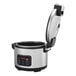 A stainless steel electric rice cooker and warmer with a digital control panel and an open hinged lid.