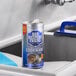 A canister of Bar Keepers Friend Superior Cookware 12 oz. cleansing and polishing powder placed on a stainless steel countertop near a sink.