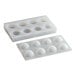 A silicone chocolate mold with eight sphere-shaped compartments, each featuring a fluted design.