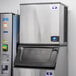 A commercial Manitowoc Indigo NXT air-cooled half dice cube ice machine with a stainless steel exterior.