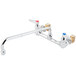 A chrome T&S wall mounted faucet with lever handles.