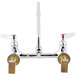 A T&S chrome wall mount faucet with lever handles.