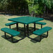 A green square perforated metal picnic table with attached benches.