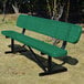 A green perforated metal bench with a backrest, designed for outdoor seating.