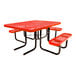 A square red expanded metal picnic table with attached benches and black metal legs.