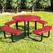 A round red perforated metal picnic table with four attached curved benches and black metal legs.