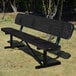 A 6-foot black perforated metal bench with a backrest, designed for outdoor use.
