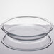 A clear glass pie pan with a round shape and slightly flared rim.