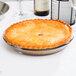 A clear glass pie pan with a baked pie inside.