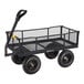 A black steel utility cart with mesh sides, four large wheels, and a pull handle.