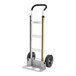 A silver and black aluminum hand truck with two wheels and a flat loading base.