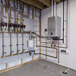 A wall-mounted Rinnai IP175S I-SERIES Plus natural gas indoor heat-only boiler with copper piping and control valves.