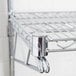 An Advance Tabco metal rod for chrome wire shelves.