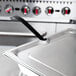 A Vollrath stainless steel slotted cover on a stainless steel tray.