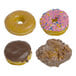 An assortment of four donuts including a glazed donut, a pink frosted donut with sprinkles, a chocolate frosted donut, and a glazed apple fritter.