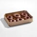A cardboard box containing six chocolate iced donut rings.