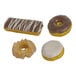 A variety pack of four assorted donuts including chocolate, glazed, and iced options.