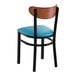 A black metal chair with a blue vinyl seat and an antique walnut wood backrest.