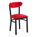 A black metal chair with a red vinyl seat and backrest.