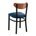 A black metal chair with a navy vinyl seat and an antique walnut wood curved backrest.