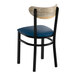 A black metal chair with a navy vinyl seat and a driftwood-finished curved wooden backrest.