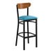 A black bar stool with a blue vinyl seat and a curved wooden backrest.