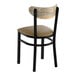 A black metal chair with a taupe vinyl seat and a driftwood-finished curved wooden backrest.