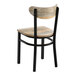 A black metal chair with a driftwood-finish wooden seat and curved backrest.