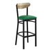 A black metal bar stool with a green vinyl seat and a driftwood-finished wooden backrest.