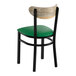 A black metal chair with a green vinyl seat and a driftwood-finished wooden backrest.