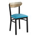 A black metal chair with a blue vinyl seat and a driftwood-finished wooden backrest.