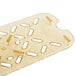 A gold plastic Vollrath Super Pan drain tray with holes.