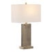 A rectangular table lamp with an antique brass base and a white linen shade.